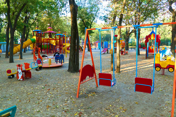 children's playground in a city Park early in the morning, various swings and carousels children's playground in a city Park early in the morning, various swings and carousels swing play equipment stock pictures, royalty-free photos & images