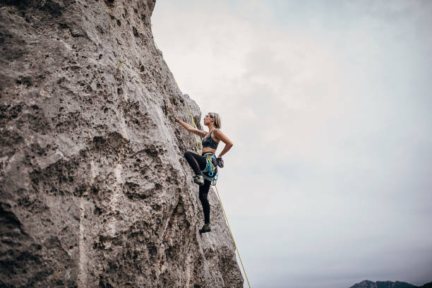 istock Young woman climbing on rocks in nature 1270763909