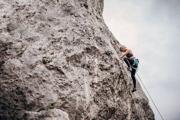 istock Young woman climbing on rocks in nature 1270763986
