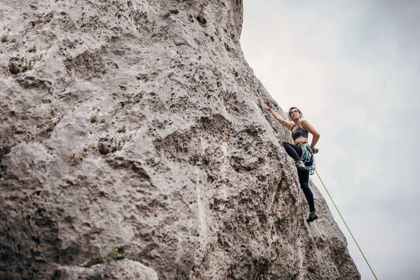 istock Young woman climbing on rocks in nature 1270764142