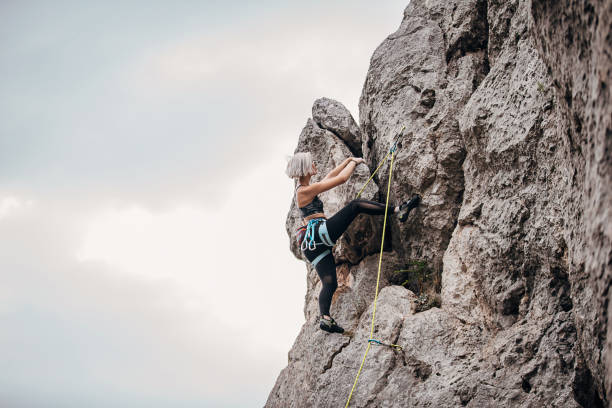 istock Young woman climber climbing on rocks in nature 1270765220