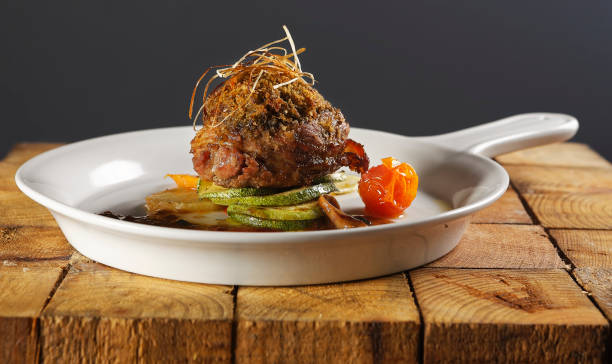 istock Roast beef wrapped with bacon in a cherry tomato and pumpkin sauce. 1270765618