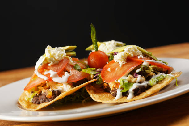 istock Chicken tostadas with beans, lettuce, tomato, fresh cheese and avocado. 1270765737