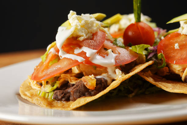 istock Chicken tostadas with beans, lettuce, tomato, fresh cheese and avocado. 1270765809