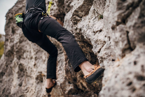 Man climbing on rock in nature alone