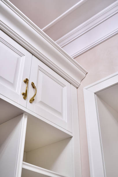 istock Classic white wardrobe with shelves in contemporary bright hallway 1270766683