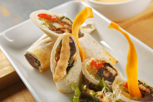 istock Chicken wrap with beans and peppers accompanied by salad and cheddar cheese dressing. 1270766802