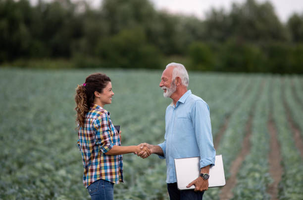 istock Farmers shaking hands in field 1270766884