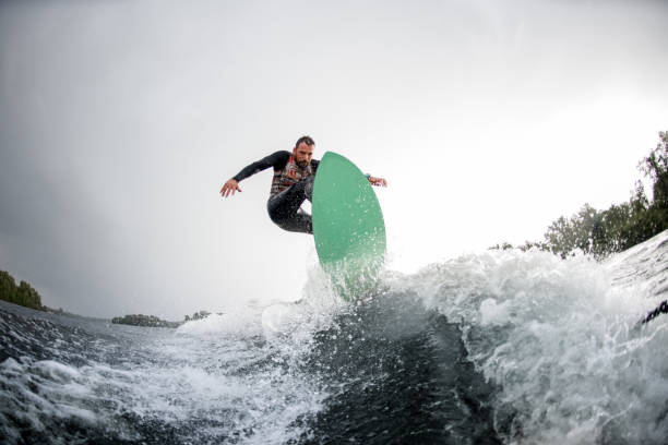 istock brave man jumping on bright wakeboard down the river water 1270766893