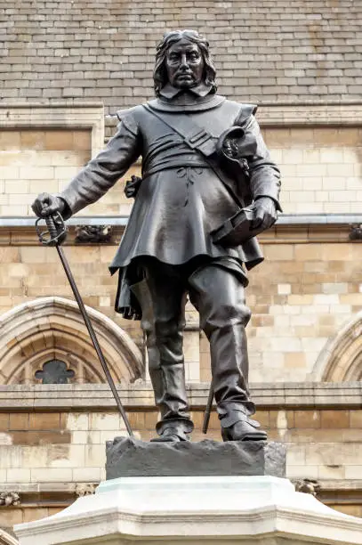 Oliver Cromwell memorial statue the Houses of Parliament London England UK unveiled in 1899 Lord Protector of the republic after the English Civil War which is a popular travel destination tourist attraction landmark stock photo image