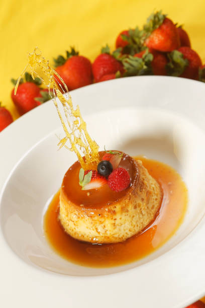 istock Vanilla custard with caramel and strawberry on yellow tablecloth. 1270767667