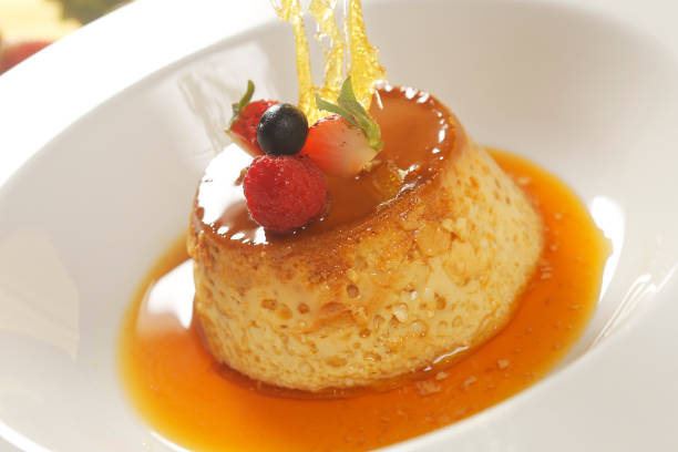 istock Vanilla custard with caramel and strawberry on yellow tablecloth. 1270767682