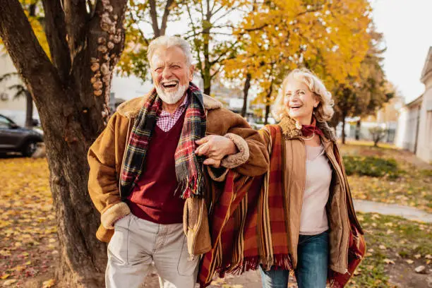 Photo of Happy senior couple enjoying in autumn day