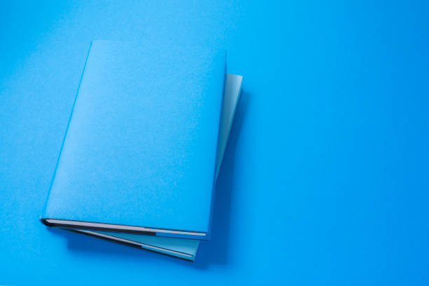 istock Blue colored cover book on blue background. Copy space 1270769846