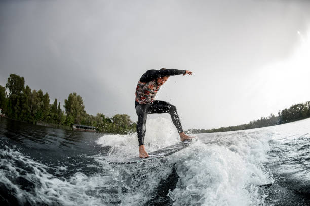 istock Handsome man rides wave off the coast with his surfboard. 1270771888