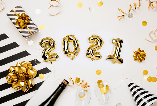 Happy New year 2021 celebration. Gold foil balloons numeral 2021 on white background with gifts