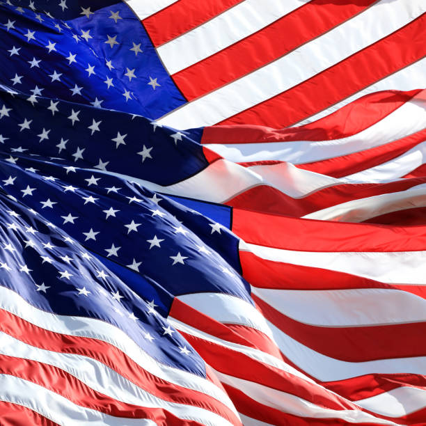 istock Close up group of waving American flags 1270773100