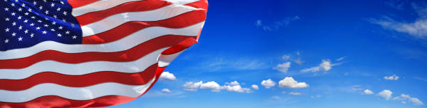 istock Close up waving American flag over blue sky copy space 1270773255