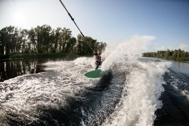 istock male athlete rides through the waves on water board 1270774237
