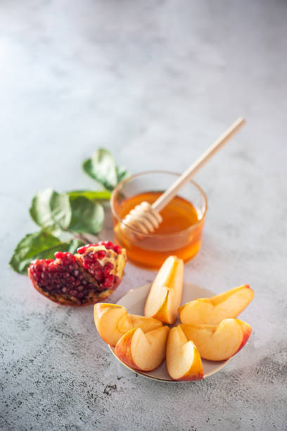 istock Apples, pomegranate and honey for Rosh Hashanah 1270774431