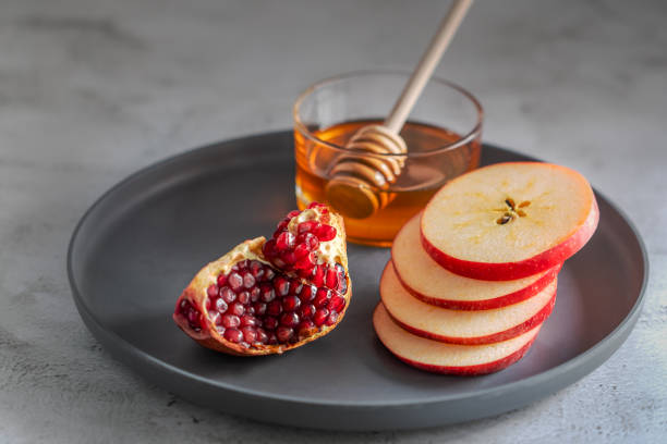 istock Apples, pomegranate and honey for Rosh Hashanah 1270774437
