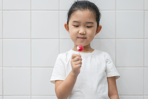 Little Girl Holding Lollipop