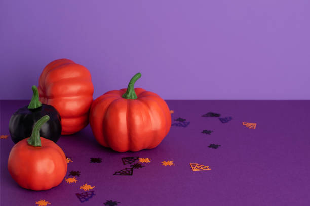 istock Halloween decorative pumpkins on purple background with copy space. 1270782243