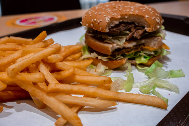 istock Double cheeseburger on a tray with freshly cooked french fries 1270783368