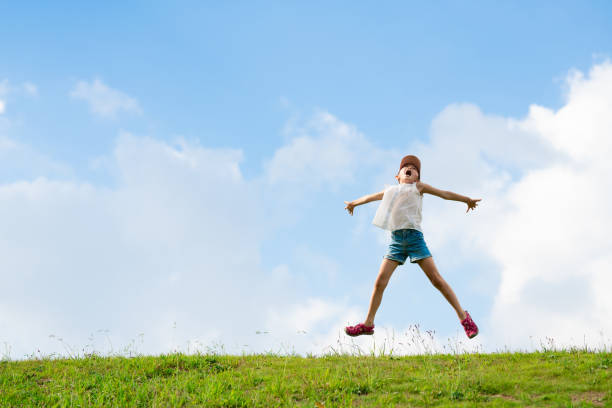 Child jumping in the meadow