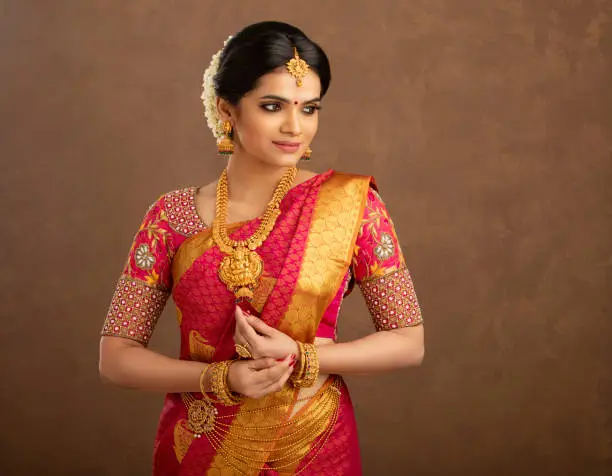 Photo of Pretty Indian young Hindu Bride in studio shot.