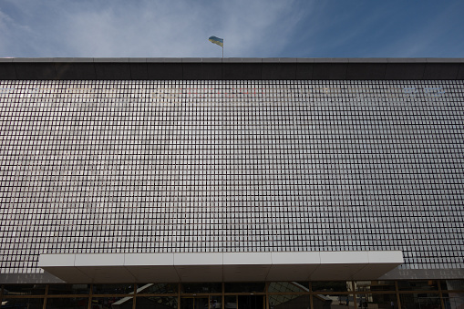 The kinetic facade of the building. Loose metal plates swing in waves in the wind
