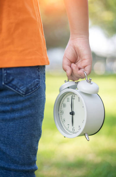 istock Child Holding Carry Alarm Clock 1270786631