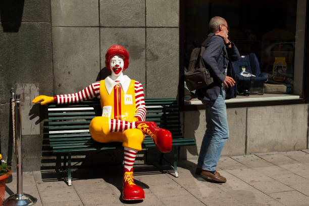 stockholm sweden july-1 - 2005  ronald mcdonald on a bench in stockholm and an unknown man leaves the bench and leaves the plastic and in from hornsgatan on södermalm in stockholm ciy,