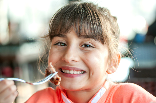 Cute Turkish girl eating meatball