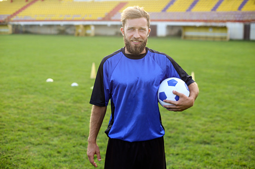 Soccer player on a field. About 30 years old, Caucasian male.