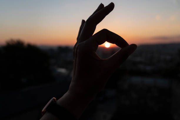 istock ok sign shown by hand on sunset background 1270789780