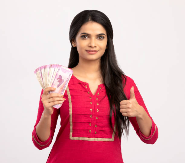 istock Happy young woman holding Indian 2000 rupee notes 1270790644