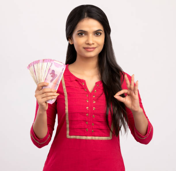 istock Happy young woman holding Indian 2000 rupee notes 1270790646