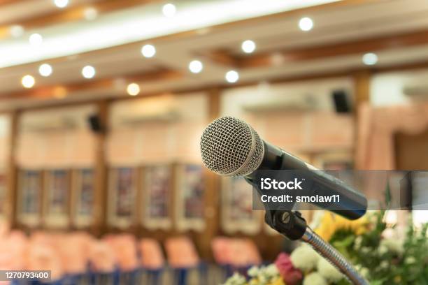 Microphones On Abstract Blurred Of Speech In Seminar Room Or Front Speaking Conference Hall Light Color Chairs For People In Event Meeting Convention Hall In Hotel Vintage Tone Stock Photo - Download Image Now