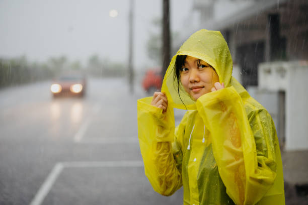 Bogotá  Colombia 29 de abril de 2024:Driving through the rain: Young woman on her motorcycle