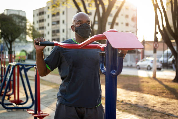 istock Senior man exercising at a public park using face mask. 1270793598