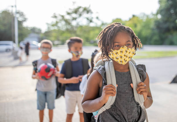 istock Diverse group of elementary school kids go back to school wearing masks 1270794762