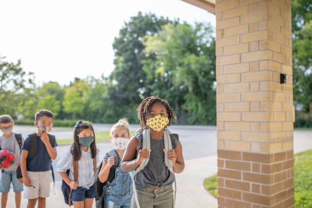 istock Diverse group of elementary school kids go back to school wearing masks 1270794770