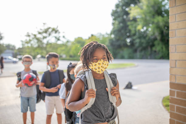 istock Diverse group of elementary school kids go back to school wearing masks 1270794774