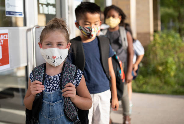 istock Diverse group of elementary school kids go back to school wearing masks 1270794778