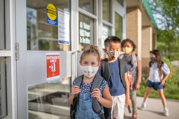 istock Diverse group of elementary school kids go back to school wearing masks 1270794782