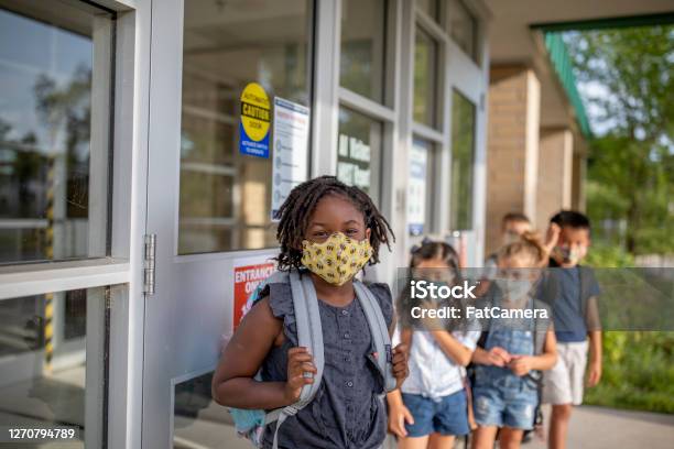 Diverse Group Of Elementary School Kids Go Back To School Wearing Masks Stock Photo - Download Image Now