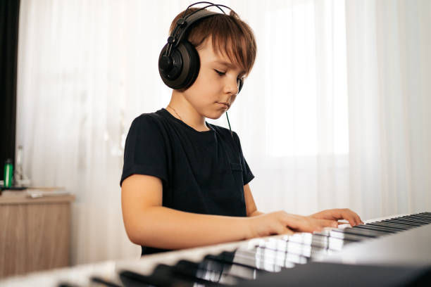 istock School boy playing synthesizer at home 1270798069