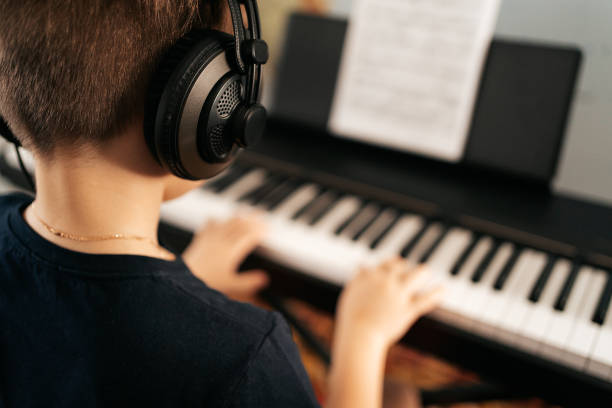 istock School boy playing synthesizer at home 1270798073