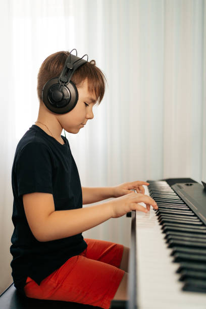 istock School boy playing synthesizer at home 1270798087